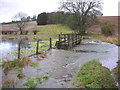 Footbridge across the flooded winterbourne in SN8 2FU
