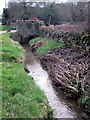 Roadside brook runs past the Old Forge in MK46 5AU