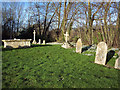 Gravestones and Snowdrops at St Editha, Baverstock in SP3 5ES