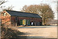 Old farm building with implement sheds in LN6 9BY