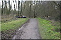 Path through Woodgate Valley Country Park, with dumped car in B32 1SD