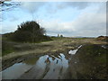 Muddy entrance to Cae'rheneglwys (= "field of the old church") in Laleston Community