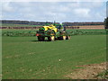 Tractor and sprayer working near Congham in PE32 1DP