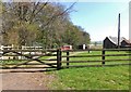 Track and agricultural buildings near Percy's Cross in NE66 4XW