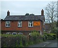 Brick-built cottage in Eardiston with an old advertisement in WR15 8GA