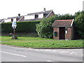 Village Sign and Bus Shelter at Road Junction, Wacton in NR15 2UF