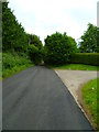 Looking north on Ball Pitt Road at the entrance to North Stanmore Farm in RG20 8SR