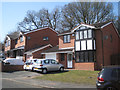 Houses abutting oak woodland, Hollowfields Close, Southcrest, Redditch in B98 7NR