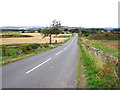 Country road heading downhill in EH40 3DY