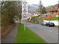 Warning signs 50 yards from traffic calming across the B4287 in Efail Fach in SA12 9SH
