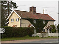 Ivy clad house at road junction in Stow Bedon and Breckles