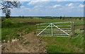 Gate and farmland along Moor Leys Lane in Waltham on the Wolds and Thorpe Arnold