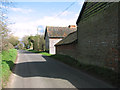 Denton Road past sheds at Dentonwash Farm in IP20 0AD