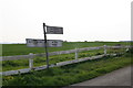 Battered signpost and fence at Stone Bridge in LN12 2RP