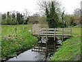 Footbridge crossing small stream in NR12 7AT