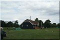 View of the cricket pavilion from the green in CM17 0PT