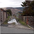 Puddles on a lane in Cwmparc in Treorchy Community