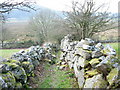 The walled lower section of the Braich-y-dinas path in LL55 3DB