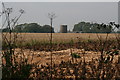 Silos at Stone Farm across a field of potatoes in LN8 3UX