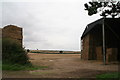 View between straw stacks, opposite Acre House in LN7 6SX
