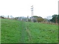Footpath from Bob's Farm goes uphill to electricity poles in RG24 9NF