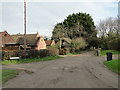 Houses and farm buildings in Frogs Hall Lane in NR20 4NU