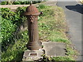 Water pump in front of houses on High Road, Cotton End in MK45 3AE