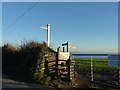 Stille, gate, footpath signpost and road signpost to Membland, near Noss Mayo in PL8 1HP