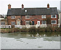 Cottages by the pond at Mulbarton Common in NR14 8JU