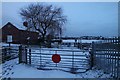 Railway crossing at dawn with snow in Penketh
