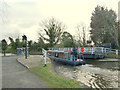 Canal boat passing through swing bridge on Wheat Lane in L40 4BS