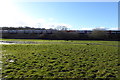 Wet field and train near Whitehall Farm in TW20 9TP