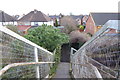 Looking east down steps from railway footbridge in TW20 9NW