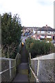 Looking west down steps from railway footbridge in TW20 9NW