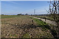 Buildings at Lodge Farm with drive seen from footpath in RG24 8AP