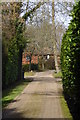 Looking along Woodland Close to house in KT24 6SB
