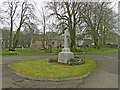 Carlton War Memorial with the church in the background in CB8 9LF