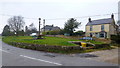 Village cross and cottages, Leafield in OX29 9NN