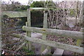 Footpath reaches stile and steps to Sheepwash Lane in RG26 5SF