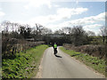 Train on the bridge, cyclist on the road in IP13 0PH