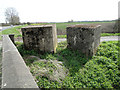 Two 1.5 metre concrete cube anti-tank blocks beside the West Lynn Drain in PE34 3LQ