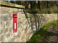 Postbox in the wall in Town Street Nidd in HG3 3BN