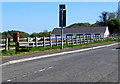 Postbox and bench alongside Kings Road, Llandybie in SA18 3YF