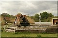 View of a water wheel and fountain in the Redbridge Fishing Lakes in IG5 0LU