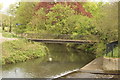 View of a footbridge over the River Lea from the elevated path in SG13 7AA