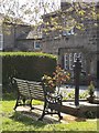 Old pump and bench, village green, Esholt in BD17 7RB