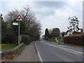 Signpost on the road passing Holy Trinity Church in Lower Beeding