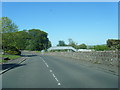 B7024 Alloway Road with railway footbridge in view in KA19 7HF