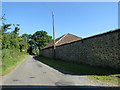 Flint wall and barn at Grange Farm, Ingham in NR12 9ST