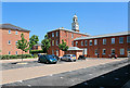 Looking across West Mews to the clock tower of North Square, Knowle in PO17 5GE